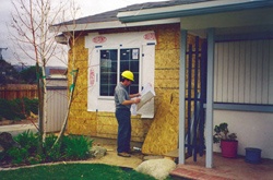 person inspecting house exterior