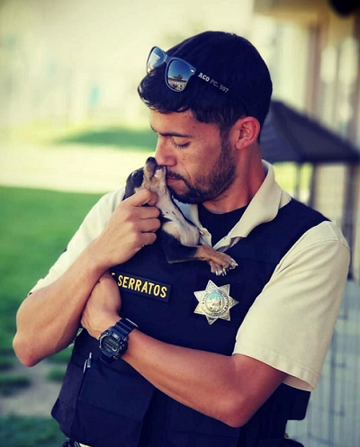 County Animal Services Officer holding dog